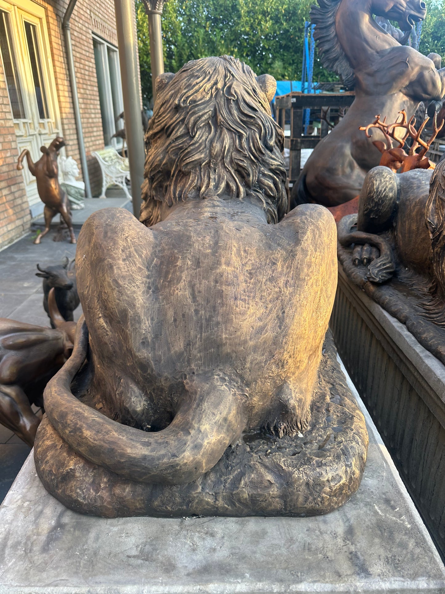 Pair of monumental bronze lions on concrete plinths