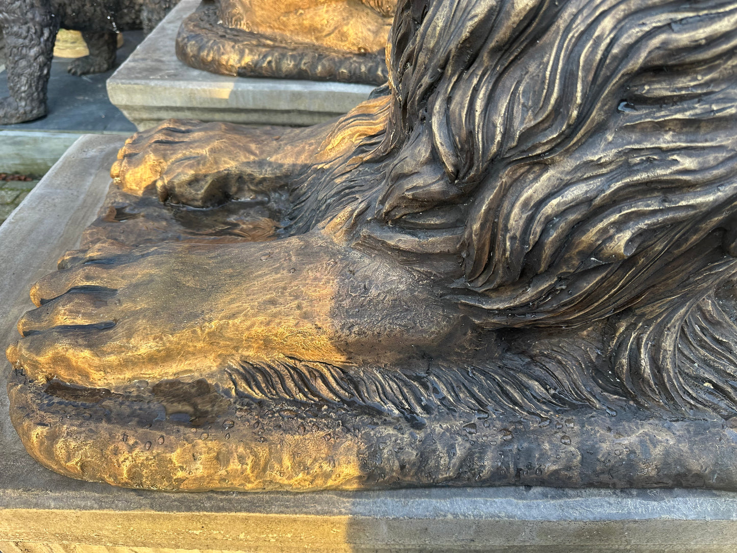 Pair of monumental bronze lions on concrete plinths