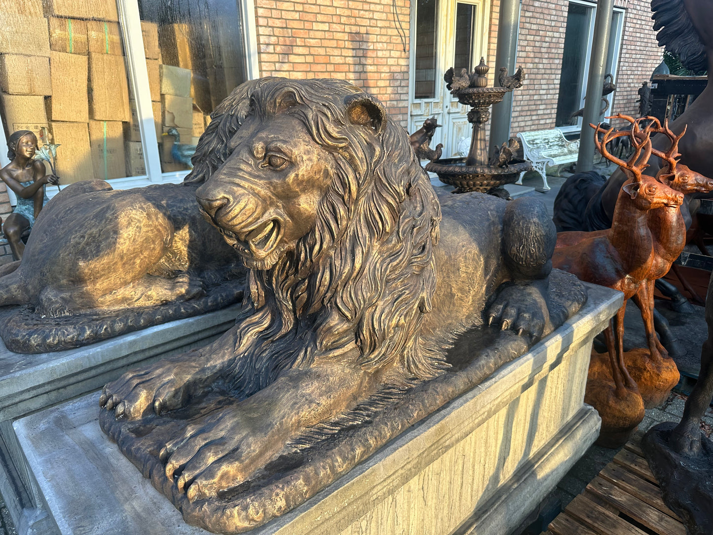 Pair of monumental bronze lions on concrete plinths