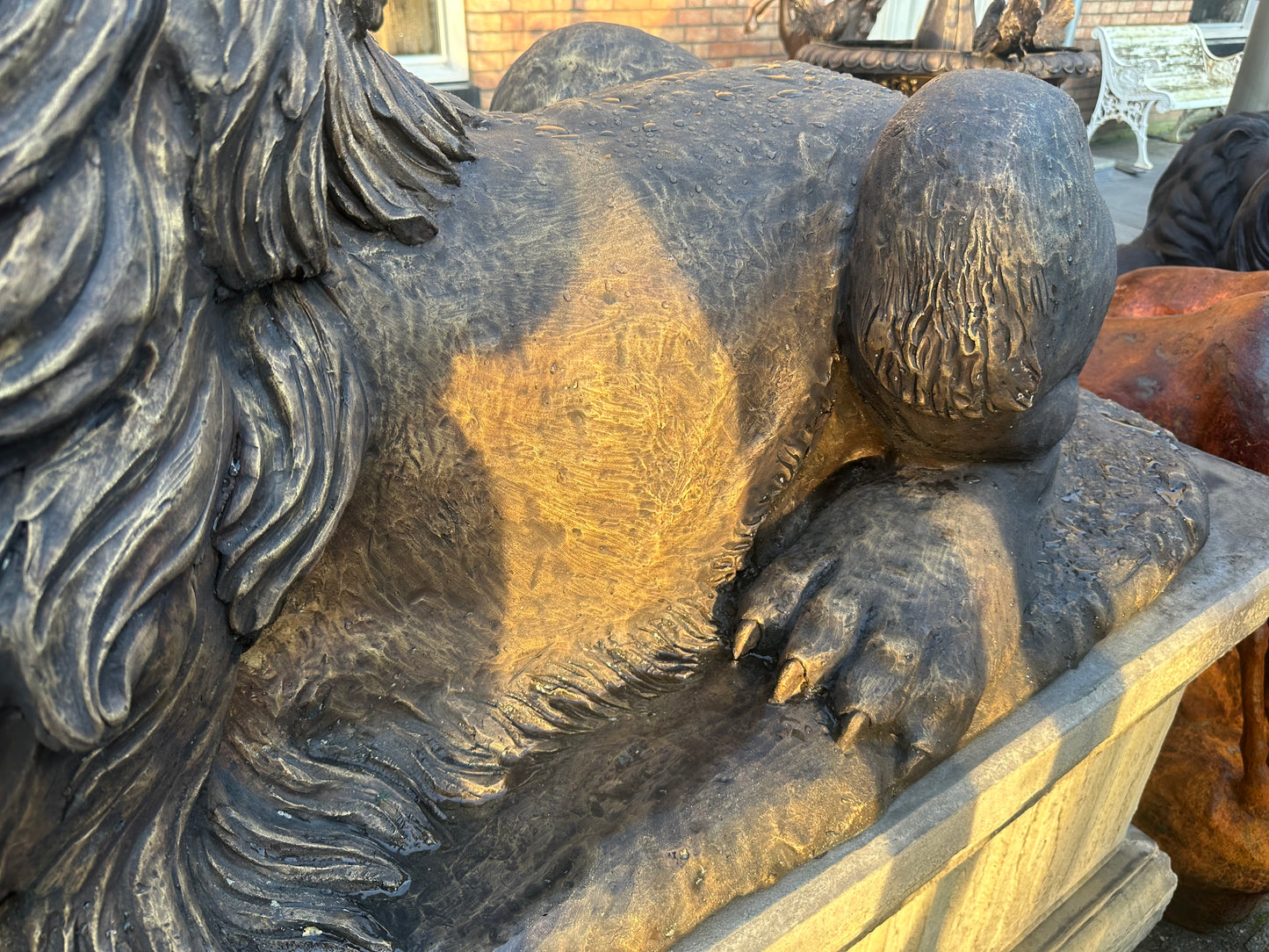 Pair of monumental bronze lions on concrete plinths